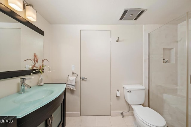 bathroom featuring tile patterned flooring, vanity, toilet, and a shower with door