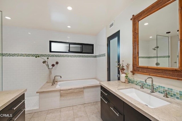 bathroom featuring tile patterned flooring, vanity, and independent shower and bath