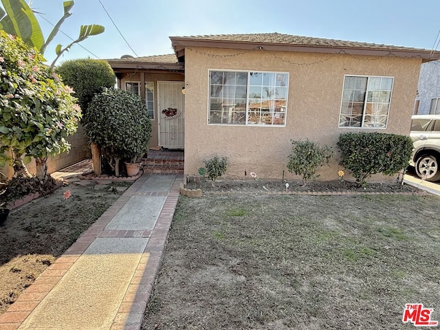 bungalow-style home featuring a front yard