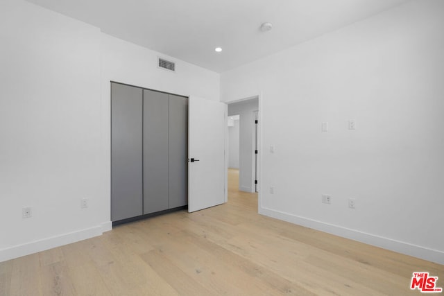 unfurnished bedroom featuring light wood-type flooring