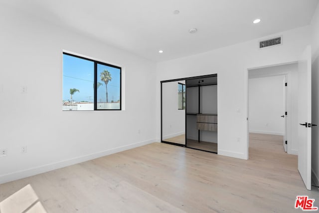 unfurnished bedroom with light wood-type flooring