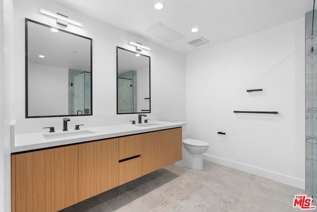 bathroom featuring a shower with shower door, toilet, and vanity