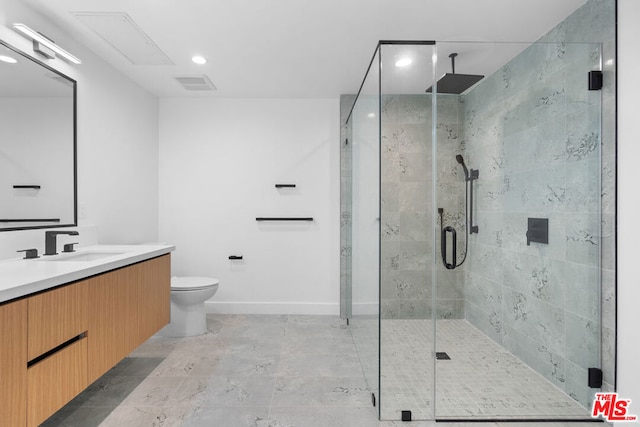 bathroom featuring toilet, an enclosed shower, and vanity