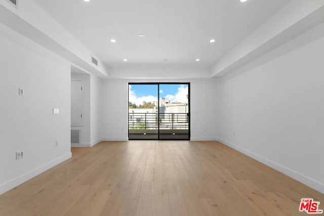 spare room with light hardwood / wood-style floors