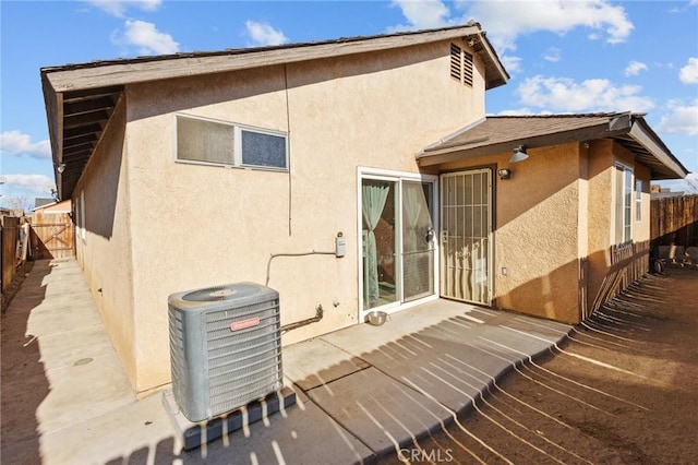 rear view of house featuring central AC and a patio area