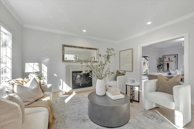 living room with light hardwood / wood-style floors and ornamental molding