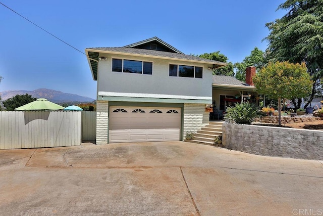 view of front facade featuring a garage and a mountain view