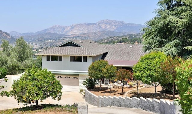 view of front of property with a mountain view and a garage