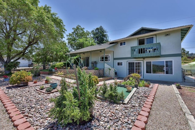 back of property with a balcony