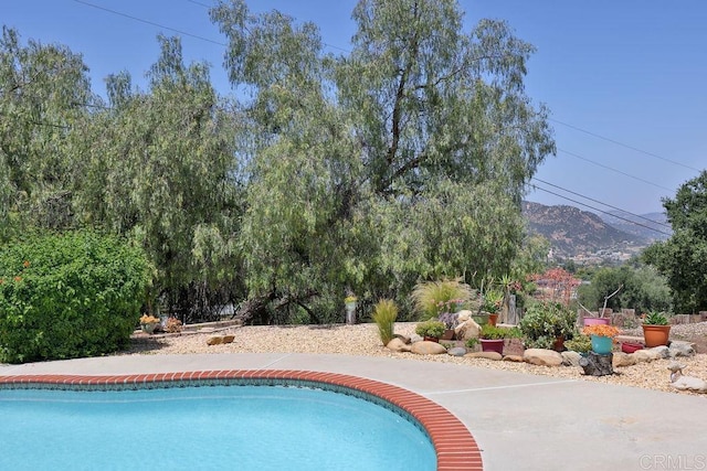 view of pool with a mountain view