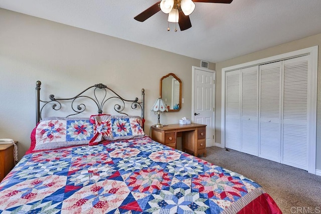 carpeted bedroom featuring ceiling fan and a closet