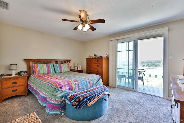 carpeted bedroom with ceiling fan and access to exterior