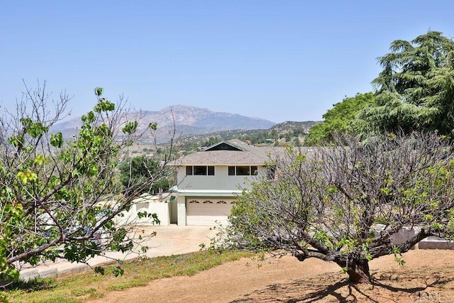 view of front of house featuring a mountain view and a garage