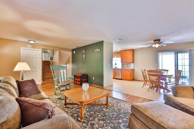 living room featuring ceiling fan and light hardwood / wood-style floors