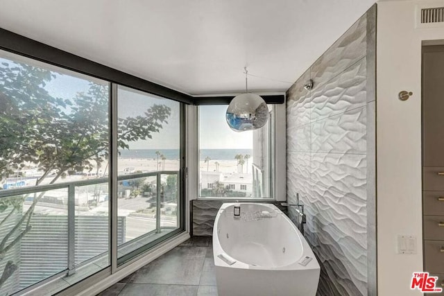 bathroom featuring a water view and a bathing tub