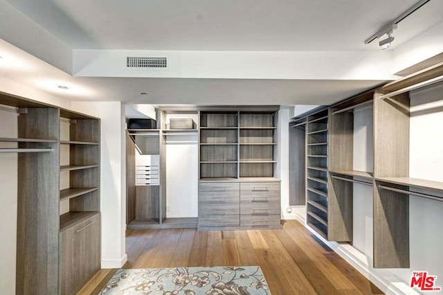 spacious closet with hardwood / wood-style floors