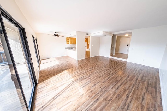 2374 Caringa Unit B, Carlsbad, CA 92009 - unfurnished living room featuring ceiling fan and light wood-type flooring