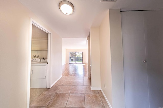 2374 Caringa Unit B, Carlsbad, CA 92009 - corridor with light tile patterned flooring and washer and dryer
