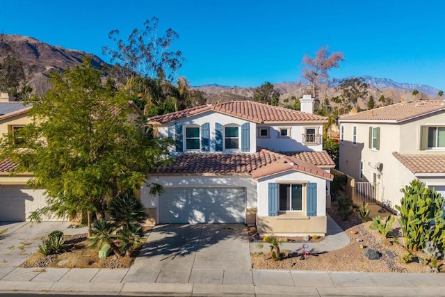 mediterranean / spanish-style home featuring a mountain view and a garage