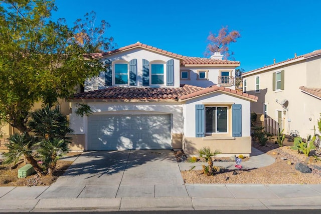 mediterranean / spanish-style home with a garage