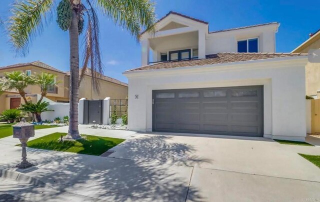 mediterranean / spanish-style house with a garage