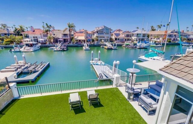 dock area featuring a yard and a water view