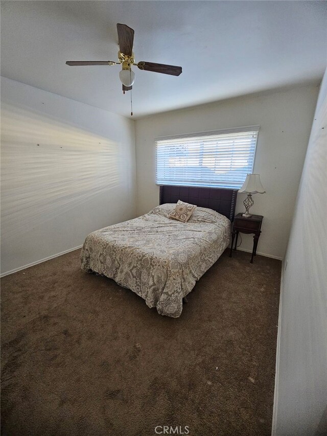 bedroom featuring ceiling fan and dark colored carpet