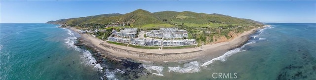 birds eye view of property with a water and mountain view and a beach view