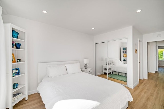 bedroom with a closet and light hardwood / wood-style floors