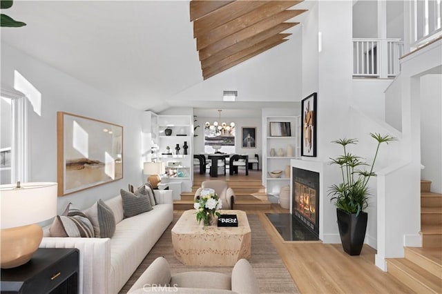 living room featuring hardwood / wood-style flooring and high vaulted ceiling