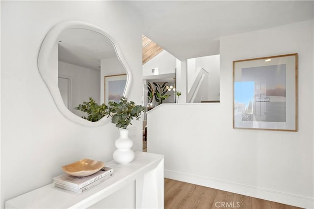 hallway with light hardwood / wood-style floors