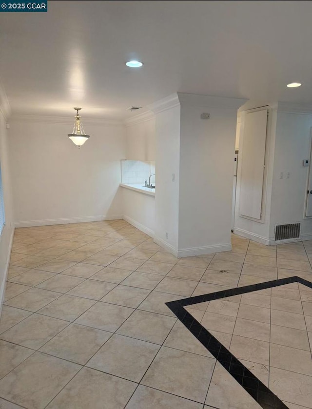 unfurnished room with light tile patterned floors and crown molding