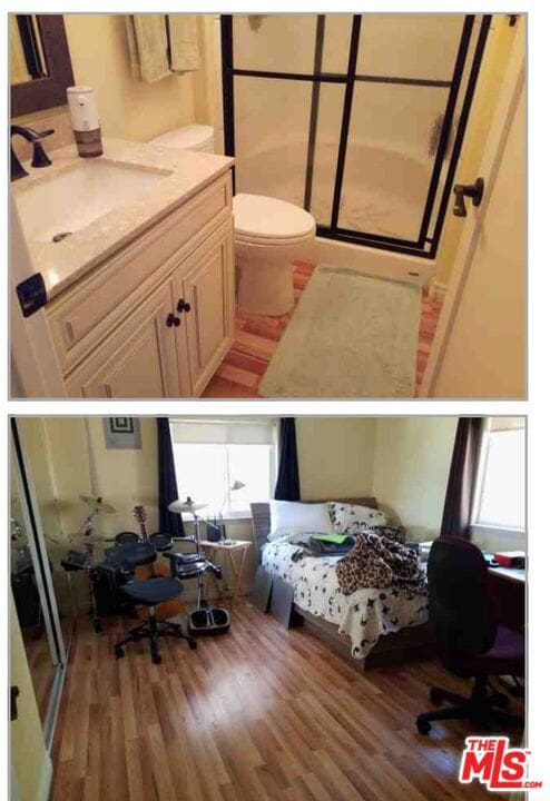 bedroom featuring sink, wood-type flooring, and multiple windows