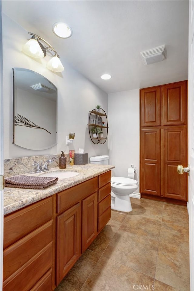 bathroom featuring toilet and vanity