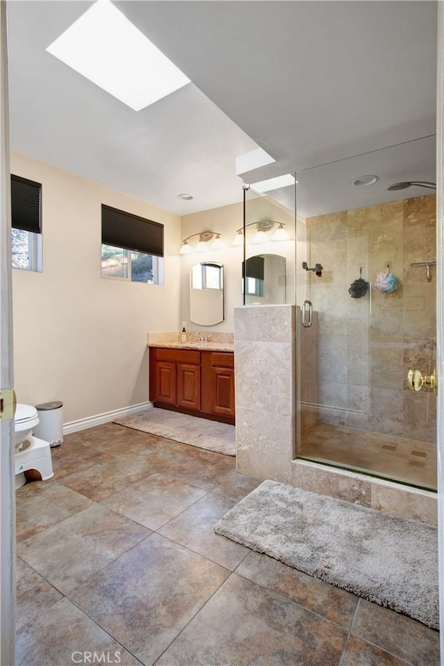 bathroom featuring toilet, vanity, and walk in shower