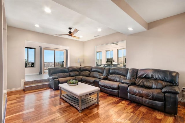 living room featuring ceiling fan and light hardwood / wood-style flooring