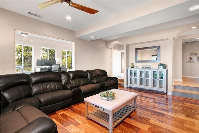 living room with ceiling fan and wood-type flooring