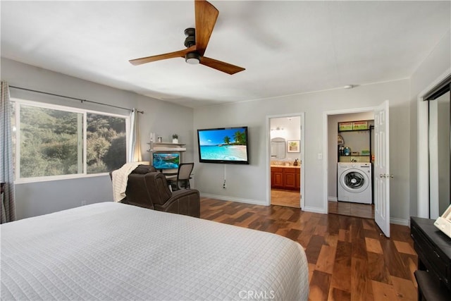 bedroom featuring ceiling fan, dark wood-type flooring, washer / dryer, and ensuite bathroom