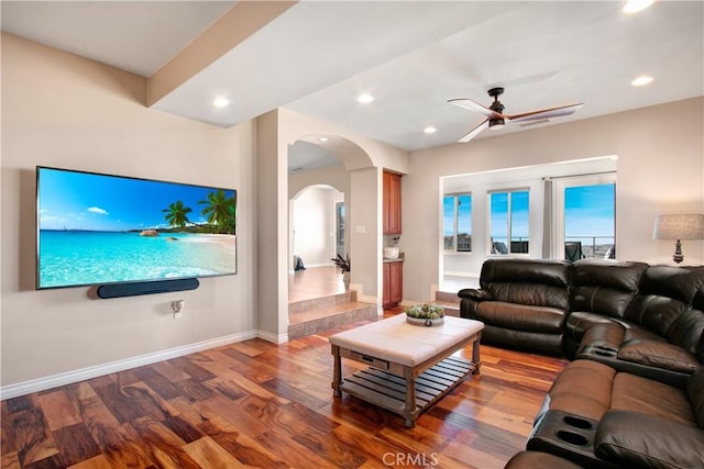 living room featuring ceiling fan and hardwood / wood-style flooring