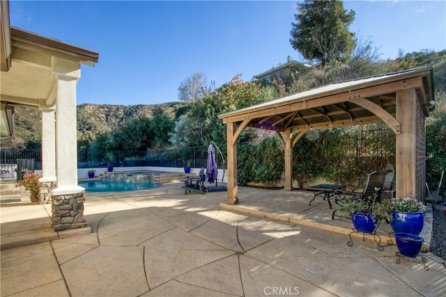 exterior space featuring a gazebo, a mountain view, and a fenced in pool