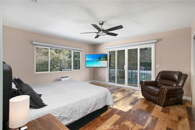 bedroom featuring ceiling fan, wood-type flooring, and access to outside