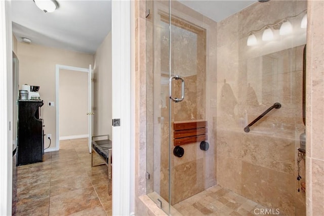 bathroom featuring a shower with shower door