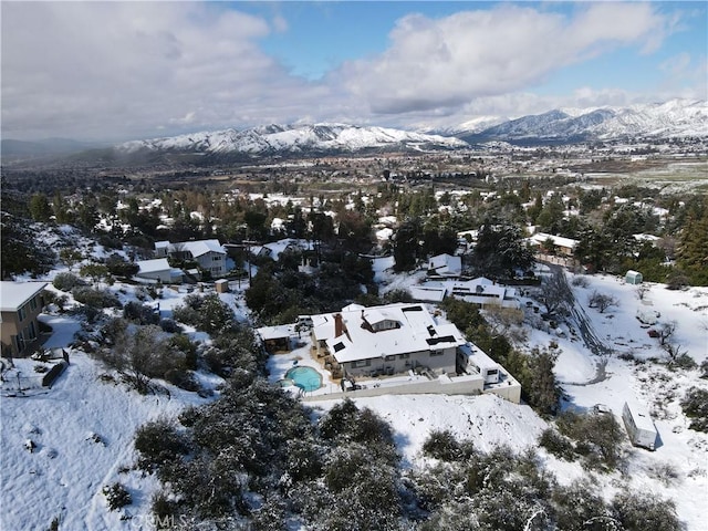 snowy aerial view with a mountain view