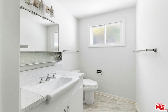 bathroom featuring toilet and vanity