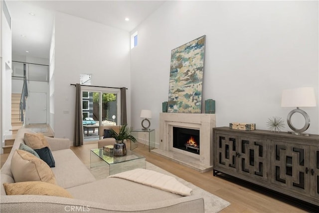 3308 Pacific Ave, Manhattan Beach, CA 90266 - living area featuring wood finished floors, stairs, a high end fireplace, a towering ceiling, and recessed lighting