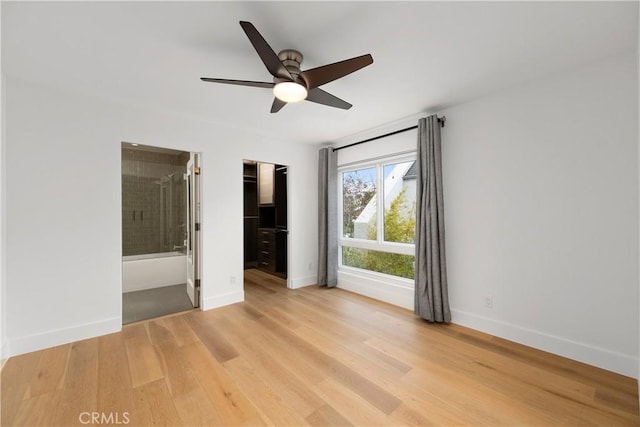 unfurnished room with ceiling fan and light wood-type flooring