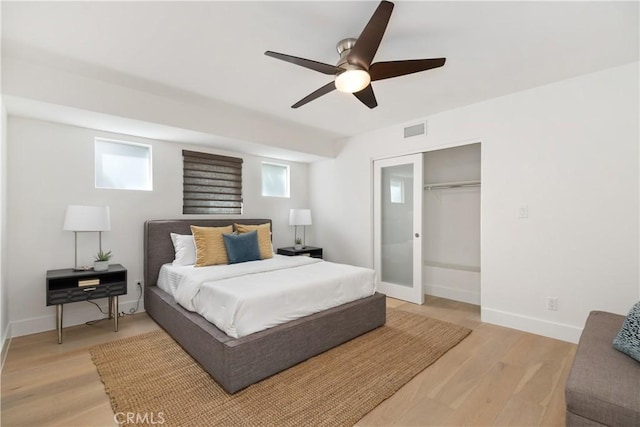 bedroom featuring ceiling fan, hardwood / wood-style flooring, and a closet