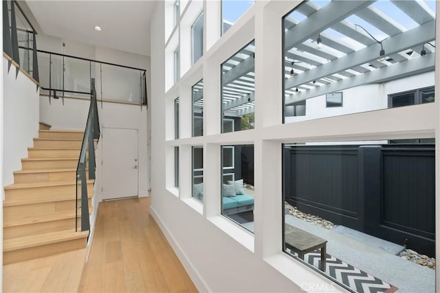 3308 Pacific Ave, Manhattan Beach, CA 90266 - corridor featuring wood finished floors, a high ceiling, baseboards, recessed lighting, and stairway