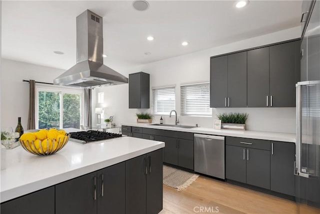 kitchen featuring light hardwood / wood-style floors, sink, appliances with stainless steel finishes, and island range hood