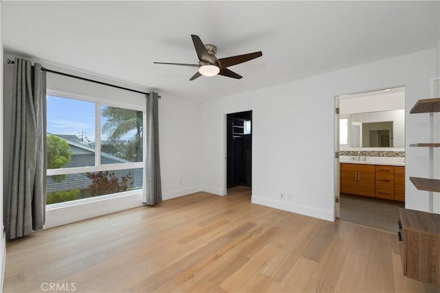 3308 Pacific Ave, Manhattan Beach, CA 90266 - unfurnished bedroom with light wood-style flooring, connected bathroom, baseboards, a spacious closet, and a sink